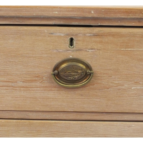 99 - Bleached wooden four drawer chest with oval brass handles embossed with a classical reclining lady, ... 