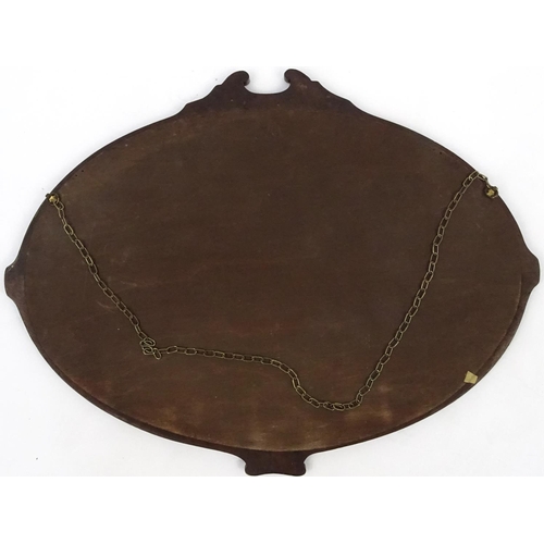 314 - Carved mahogany oval mirror with bevelled plate, 83cm x 63cm