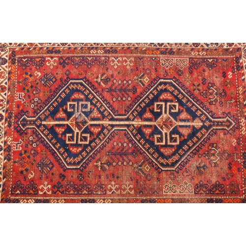2033 - Rectangular Persian rug, decorated all over with sttylised floral motifs onto a red ground, 150cm x ... 