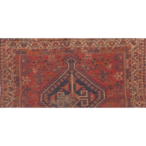 2033 - Rectangular Persian rug, decorated all over with sttylised floral motifs onto a red ground, 150cm x ... 
