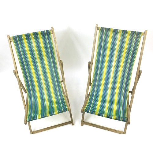 76 - Pair of vintage folding wooden deckchairs