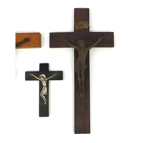 457 - Four religious interest crucifix, including a gilt bronze example mounted on a rosewood crucifix, th... 