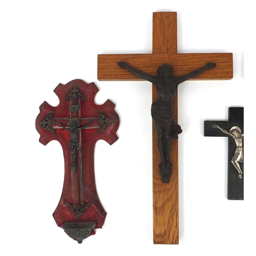 457 - Four religious interest crucifix, including a gilt bronze example mounted on a rosewood crucifix, th... 