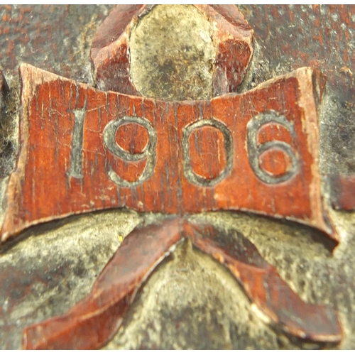 37 - Carved mahogany tripod stool engraved 1906, 32cm high, 29cm in diameter