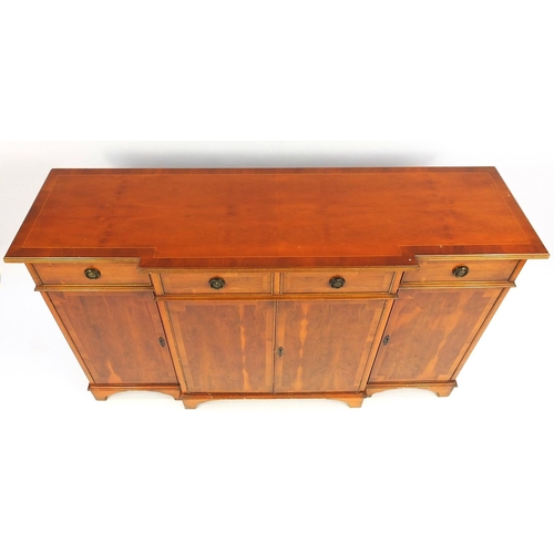 38 - Inlaid yew break front sideboard fitted with four frieze drawers above four cupboard doors, 92cm hig... 