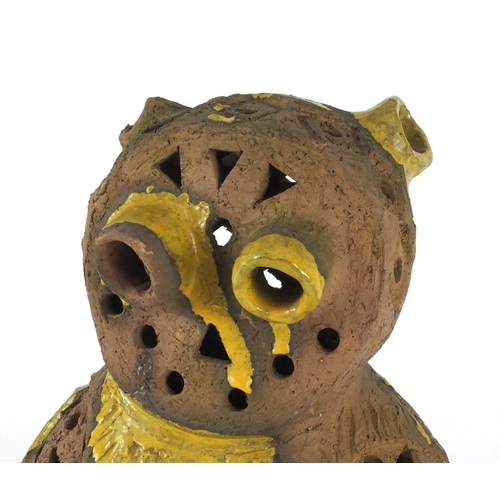 487 - Decorative partially glazed owl, with pierced decoration, 33cm high