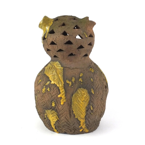 487 - Decorative partially glazed owl, with pierced decoration, 33cm high