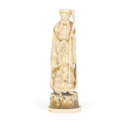 547 - Japanese carved ivory okimno of an elder with a crane, standing upon a tortoise, 17cm high