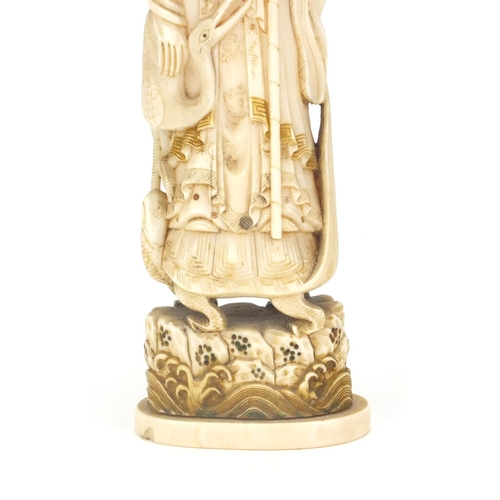 547 - Japanese carved ivory okimno of an elder with a crane, standing upon a tortoise, 17cm high