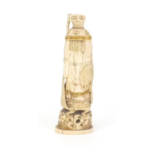 547 - Japanese carved ivory okimno of an elder with a crane, standing upon a tortoise, 17cm high