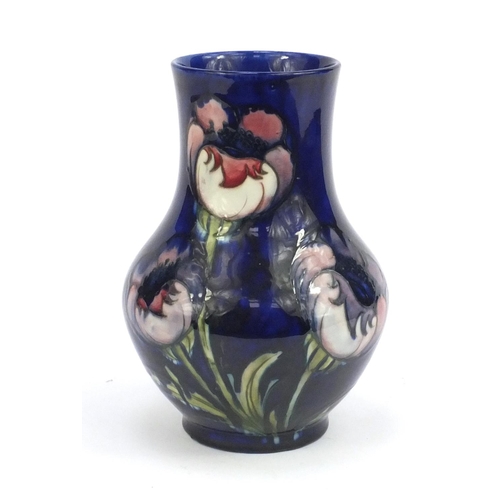 714 - Moorcroft Anemone pattern baluster vase, onto a blue ground, signed and impressed factory marks to t... 