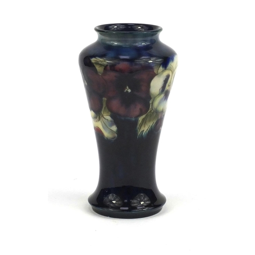 713 - Moorcroft pansy pattern vase, onto a blue ground, factory marks and M72 to the base, 18cm high