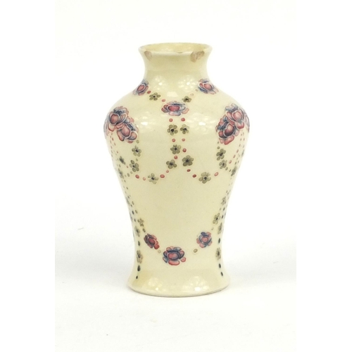 715 - Moorcroft for Liberty & Co baluster vase hand painted and tube lined with flowers, factory marks to ... 