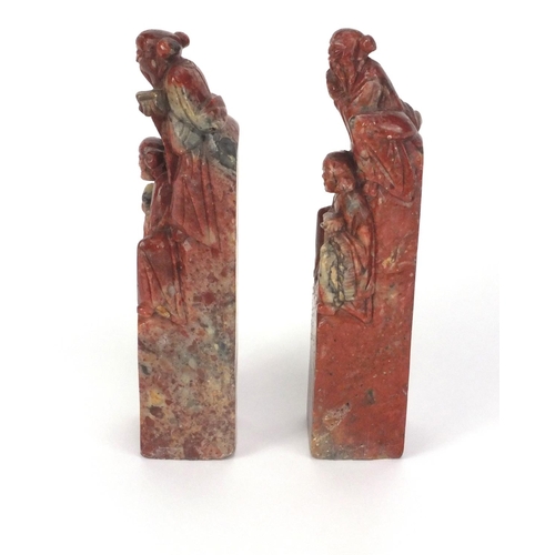 578 - Pair of Chinese soapstone seals, each carved with two elders, each 16cm high