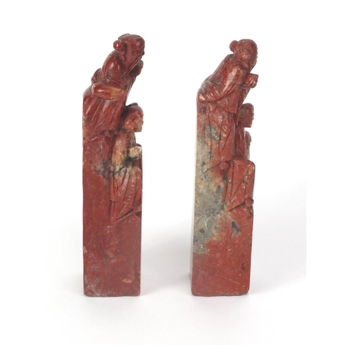 578 - Pair of Chinese soapstone seals, each carved with two elders, each 16cm high