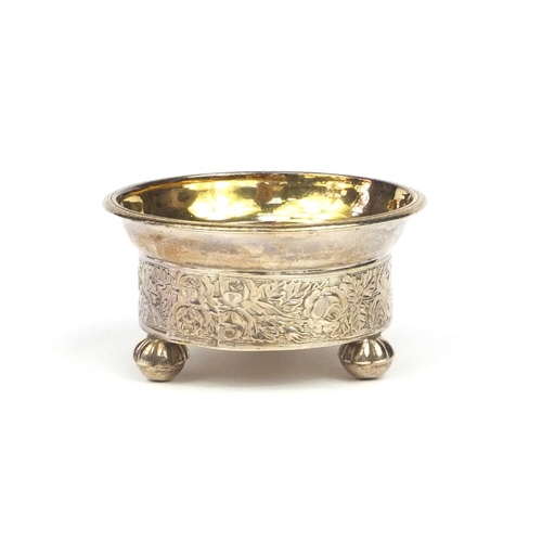 809 - Russian silver salt with gilt interior and raised on ball feet, decorated with a continuous band of ... 