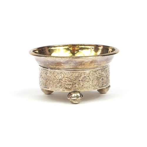 809 - Russian silver salt with gilt interior and raised on ball feet, decorated with a continuous band of ... 