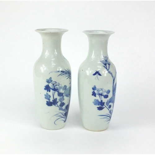 499 - Pair of Chinese blue and white porcelain baluster shaped vases, both hand painted with birds and but... 