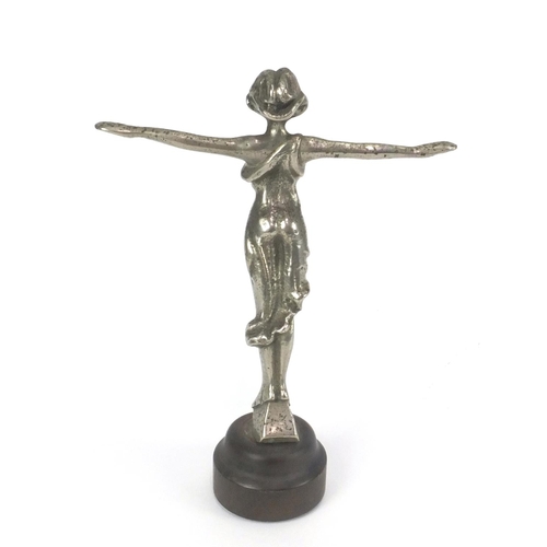 117 - Chrome car mascot of a female wearing a flowing dress, on a circular wooden base, overall 18.5cm hig... 