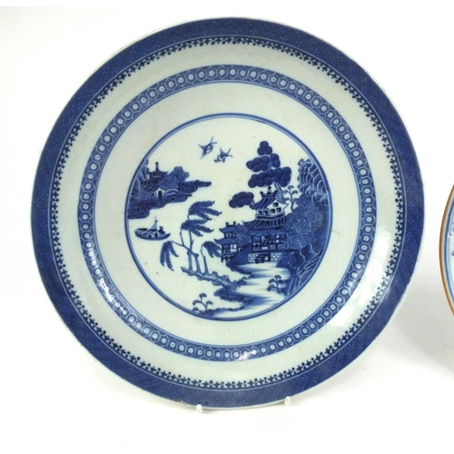 504 - Two Chinese porcelain dishes, one hand painted with a river landscape the other with flowers and emb... 