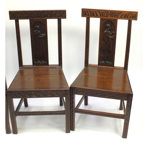 2044 - Four Victorian oak chairs to include a carver, the slats carved with figures, each 92cm high