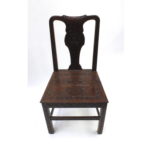 2071 - Antique oak hall chair, the splat carved with a figure and lozenge carved seat, 97cm high