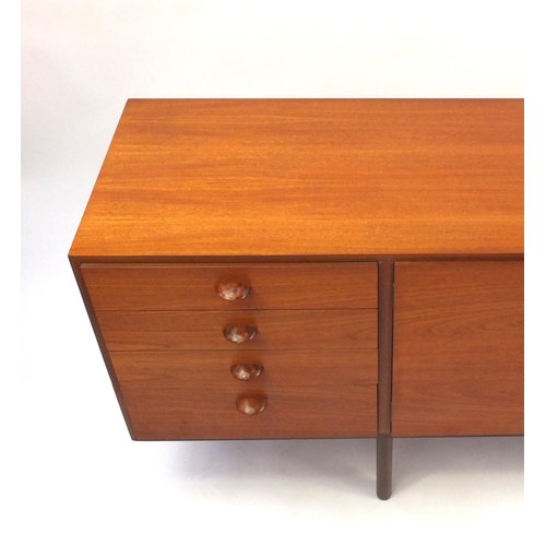 2021 - 1970's teak sideboard fitted with three cupboard doors and four graduated drawers, 77cm high x 199cm... 