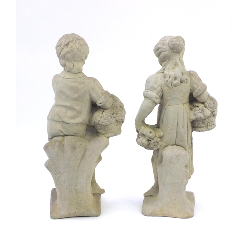 2108 - Pair of garden stoneware figures, one of a young boy carrying a basket the other of a young girl hol... 