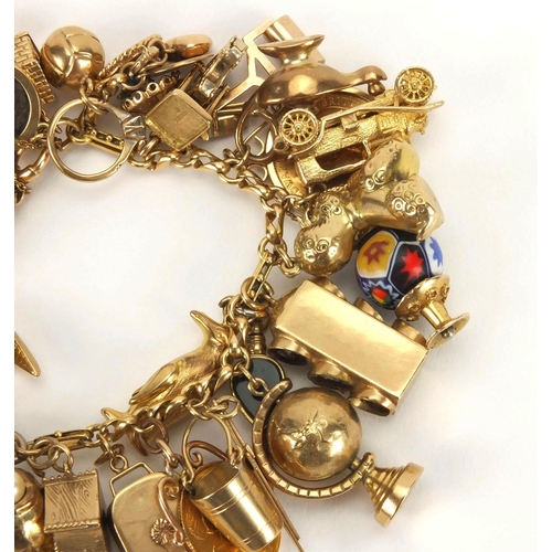 898 - Good 9ct gold charm bracelet with approximately forty mostly gold charms, including two full soverei... 