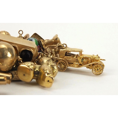 898 - Good 9ct gold charm bracelet with approximately forty mostly gold charms, including two full soverei... 