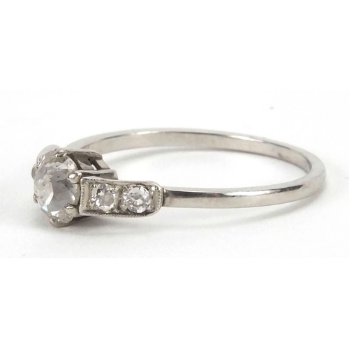 931 - Unmarked white metal diamond solitaire ring, set with four diamonds to the shoulders, size Q, approx... 