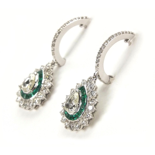 909 - Pair of 18ct white gold pear shaped diamond and emerald drop earrings, 3.5cm long,  approximate weig... 