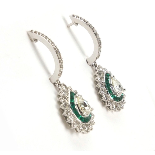 909 - Pair of 18ct white gold pear shaped diamond and emerald drop earrings, 3.5cm long,  approximate weig... 