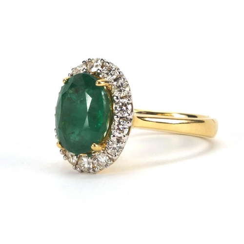 916 - 18ct emerald and diamond ring set with a central emerald surrounded by fourteen diamonds, size N, ap... 