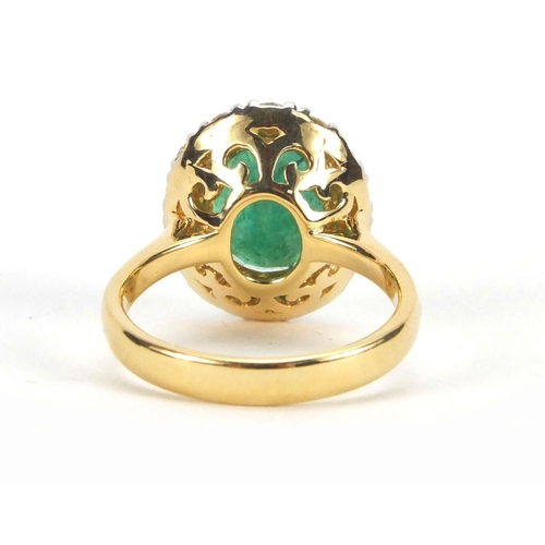 916 - 18ct emerald and diamond ring set with a central emerald surrounded by fourteen diamonds, size N, ap... 