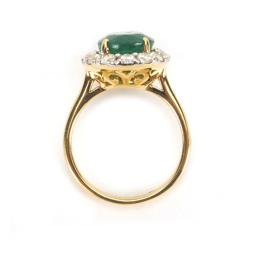 916 - 18ct emerald and diamond ring set with a central emerald surrounded by fourteen diamonds, size N, ap... 