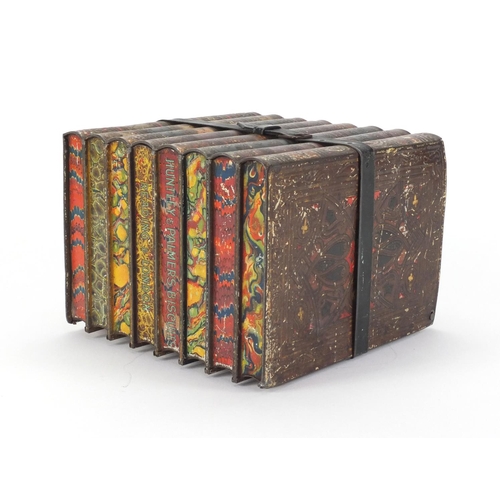 60 - Huntley & Palmers biscuit tin in the form of eight stacked books, 17cm high