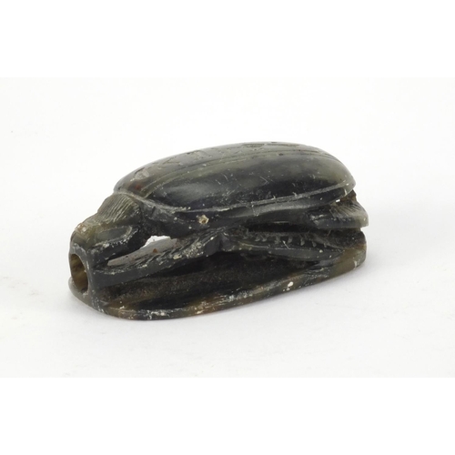 635 - Egyptian hard stone scarab beetle carved with hieroglyphics, 8.5cm in length