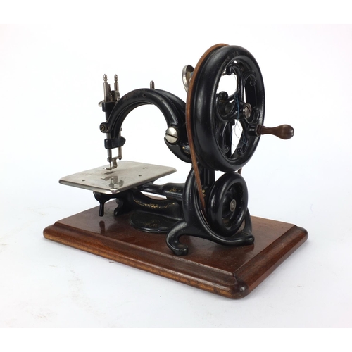 52 - 19th century Wilcox and Gibbs mechanical sewing machine, with carrying case, 27cm high