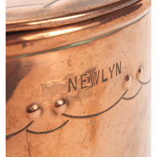 792 - Arts & Crafts Newlyn copper tea caddy of oval form with handle, embossed with fruit, 12.5cm high exc... 