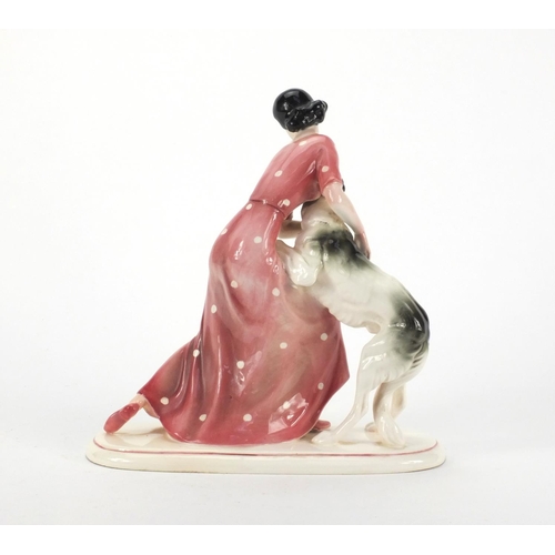 760 - Art Deco Katzhutte figure of a young female with her dog, factory marks to the base, 25cm high