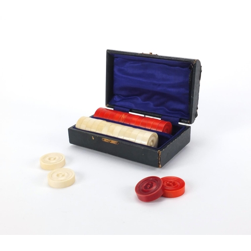 391 - Part stained ivory draughts housed in a velvet lined fitted case, the case 14cm in diameter