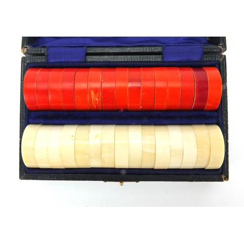 391 - Part stained ivory draughts housed in a velvet lined fitted case, the case 14cm in diameter