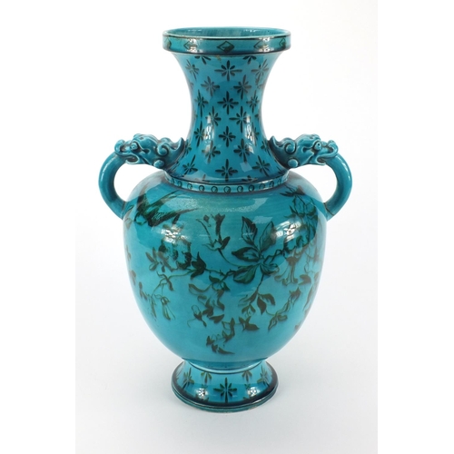 728 - Blue glazed art pottery vase with dragon handles, hand painted with a swallow amongst flowers, facto... 