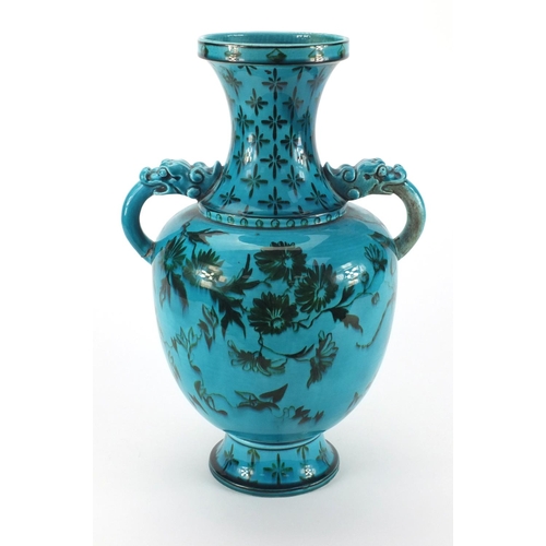 728 - Blue glazed art pottery vase with dragon handles, hand painted with a swallow amongst flowers, facto... 