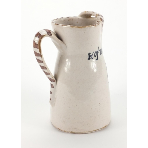 676 - Continental pottery jug hand painted with crest  and Hostal Castilla, 20cm high