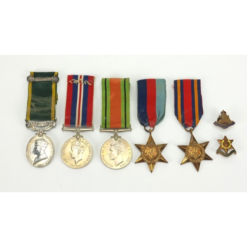 264 - British Military George VI and later medals with two badges, the Territorial Efficient Service medal... 