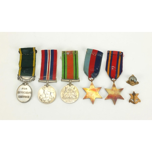 264 - British Military George VI and later medals with two badges, the Territorial Efficient Service medal... 