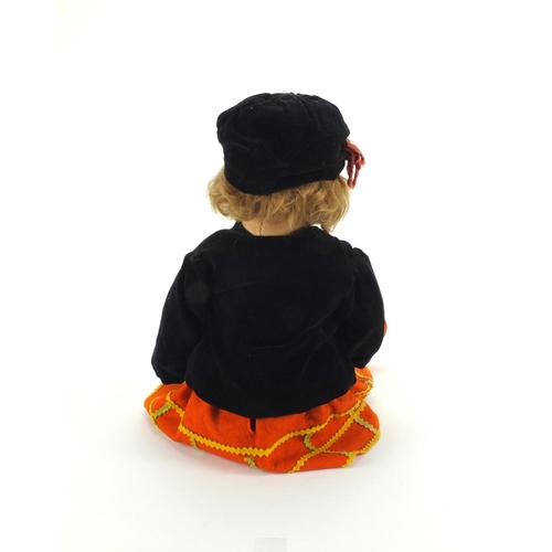 370 - 1930's Norah Wellings felt doll wearing and orange dress, black overcoat and hat, 53cm in length