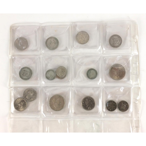 212 - Queen Anne and later predominantly British coinage, some silver housed in a folder including a 1711 ... 